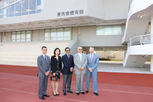 To commemorate the official opening of the Jockey Club Sports Building, Mrs Betty Fung Ching Suk-yee JP, Permanent Secretary for Home Affairs (2nd left); Mr Anthony W K Chow SBS JP, Deputy Chairman of The Hong Kong Jockey Club (HKJC) (2nd right); Mr Carlson Tong Ka-shing SBS JP, Chairman of the HKSI (3rd left); Mr Michael Lee Tze-hau JP, Vice-Chairman of the HKSI (1st left) and Mr Winfried Engelbrecht-Bresges JP, Chief Executive Officer of The HKJC (1st right), take a photo in front of the Building.